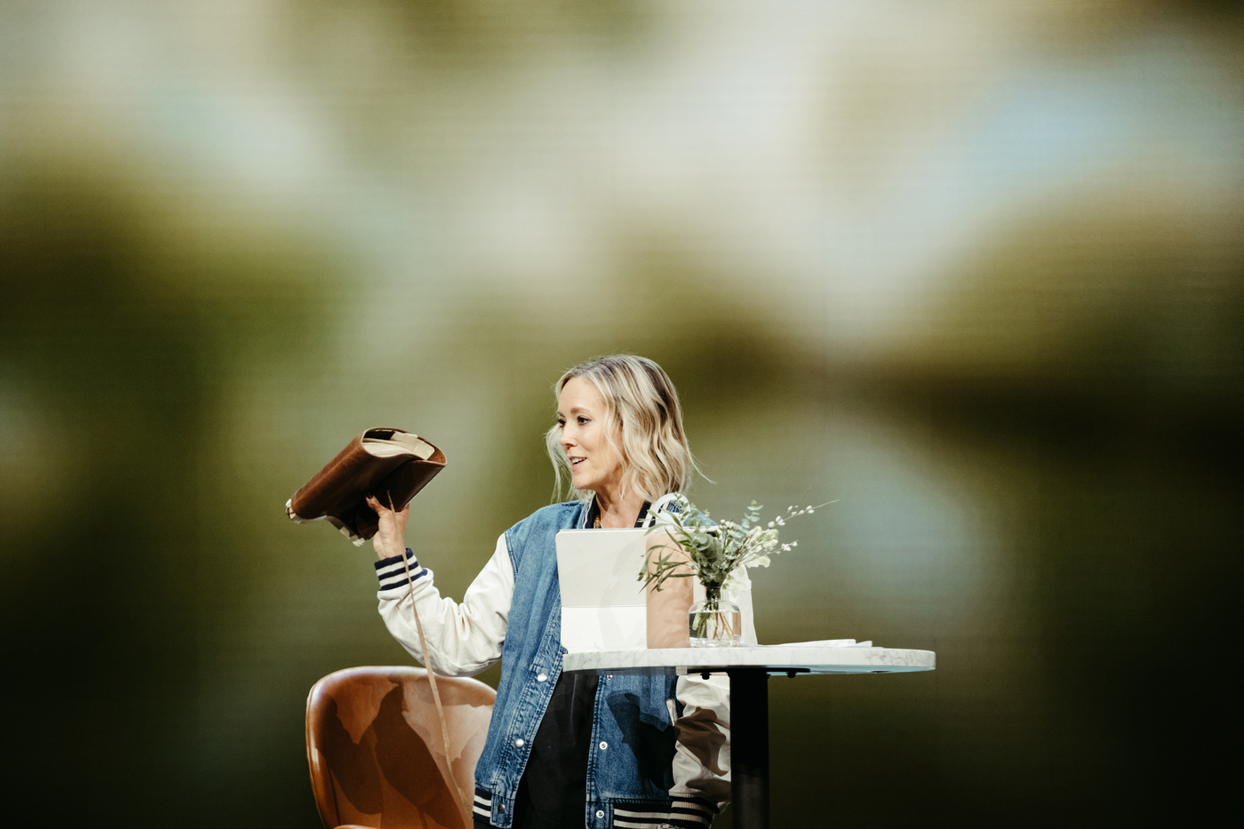 Aynsley holding up a Bible while teaching